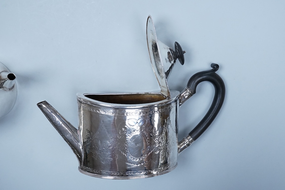 A George III engraved silver oval teapot, makers mark RD?, London, 1794, together with one other Georgian silver teapot with associated silver cover, gross weight 26.8oz.